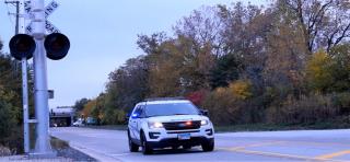 a police vehicle near a railroad crossing
